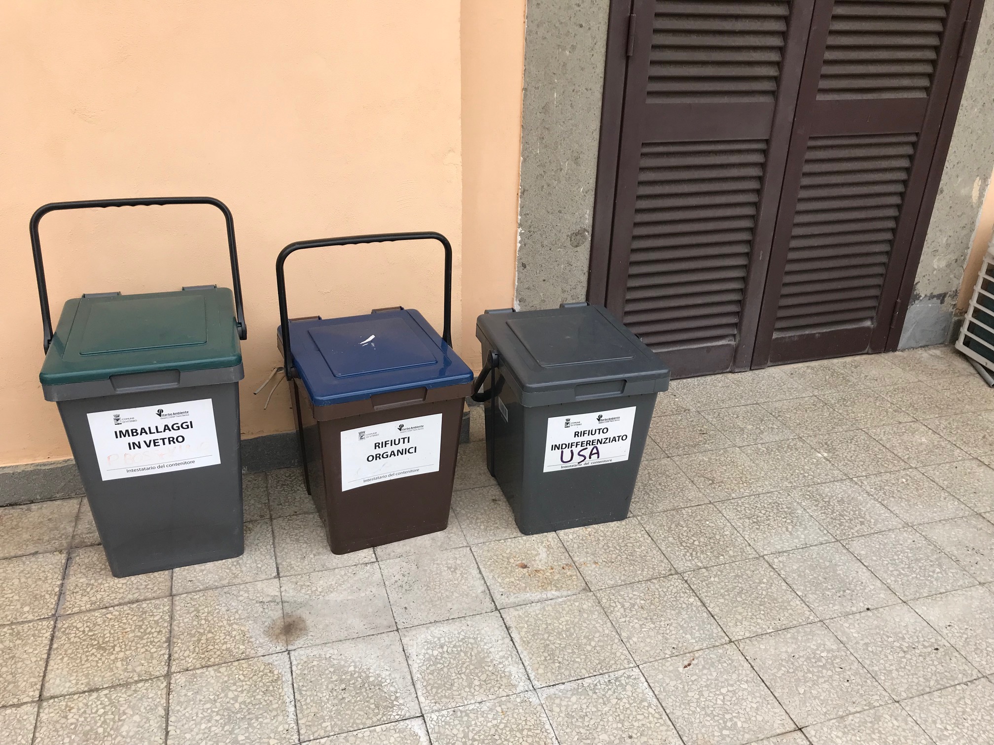 A row of trash bins